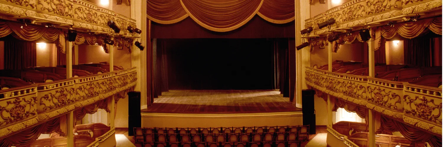 Dramatic theater stage lighting with purple and blue beams